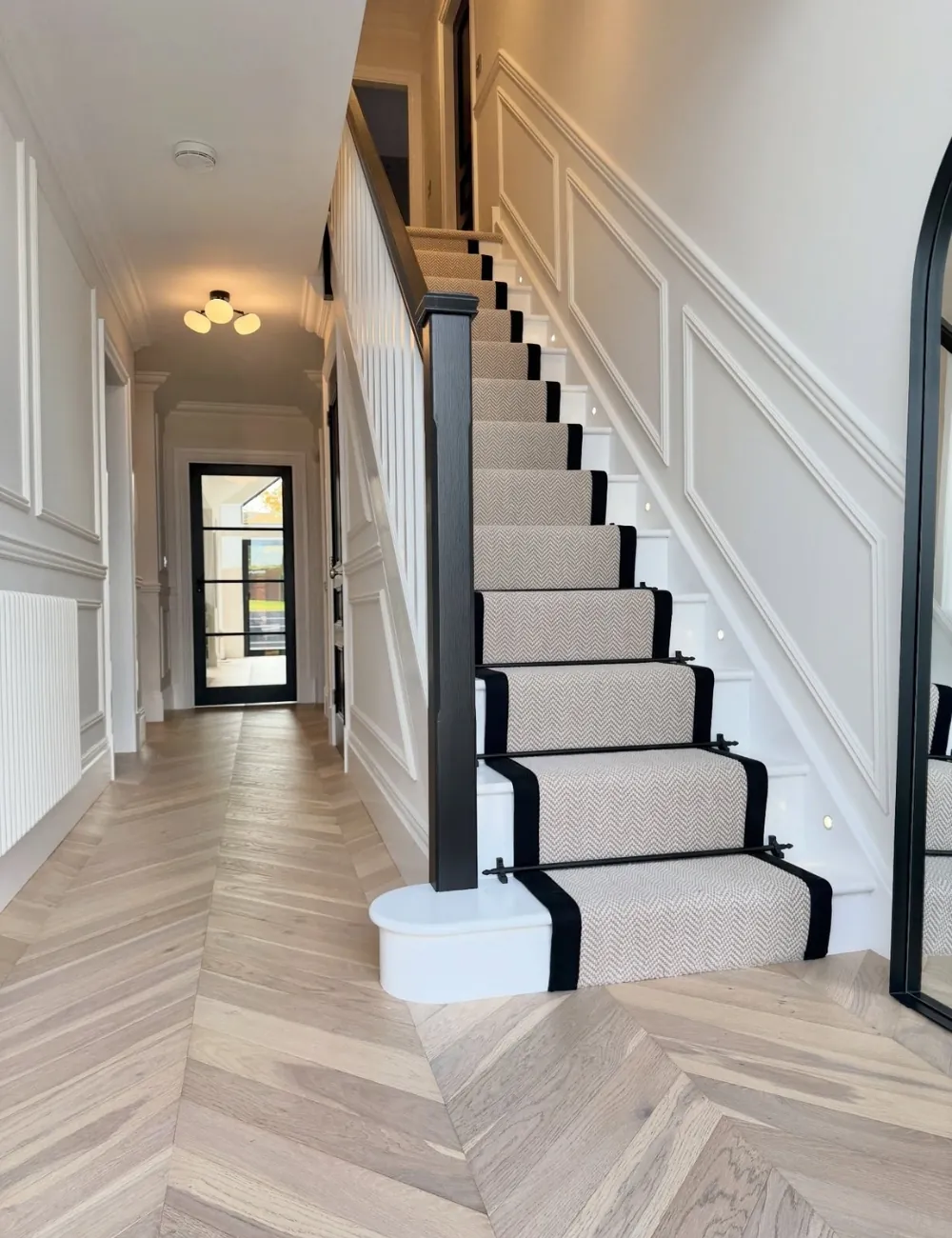 Elegant bordered stair carpet runner.